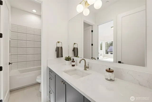 a living room with furniture and floor to ceiling windows