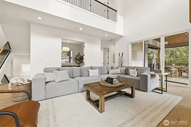 a balcony with wooden floor table and chairs