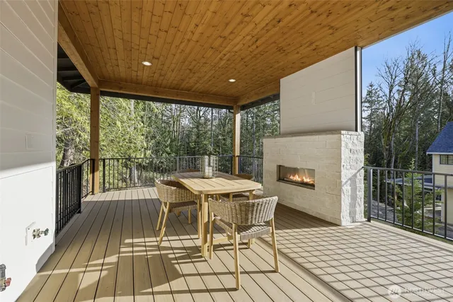 a living room with stainless steel appliances kitchen island granite countertop furniture and a wooden floor