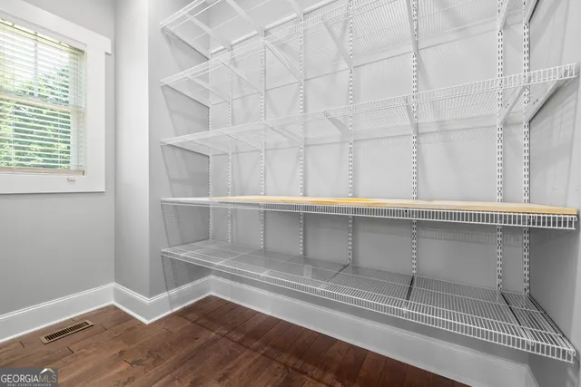 a view of walk in closet with empty racks