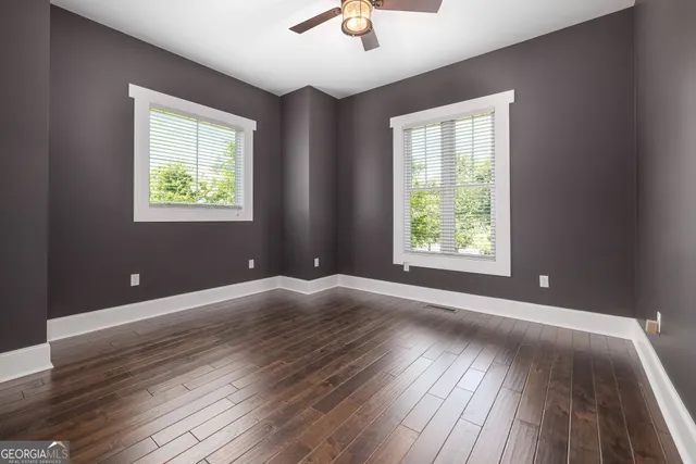 wooden floor in an empty room with a window