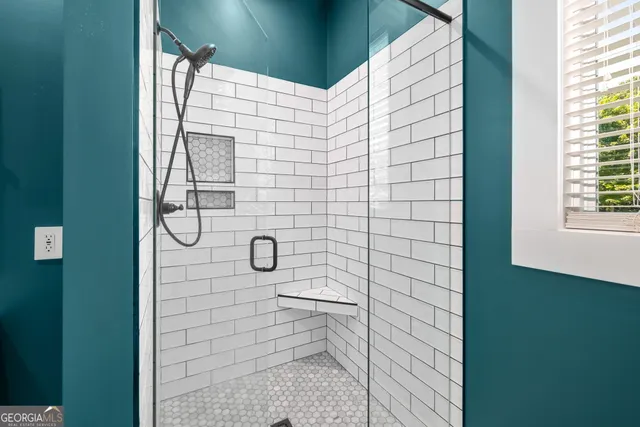 a bathroom with a white toilet and a shower