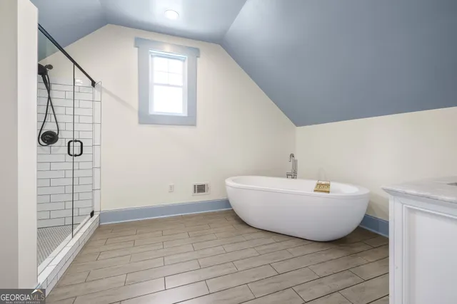 a bathroom with a bathtub and shower