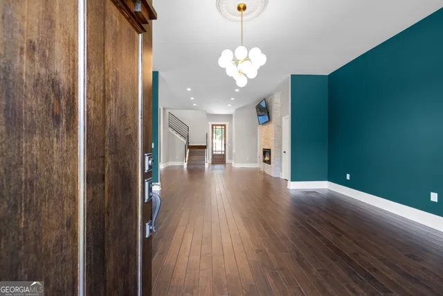 a view of a hallway with wooden floor