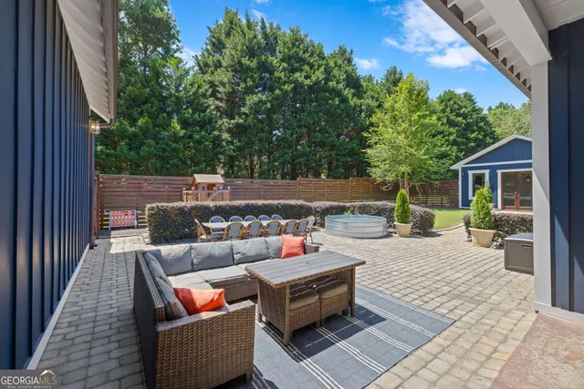 a backyard of a house with outdoor seating