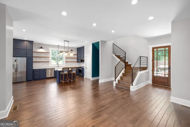 a living room with fireplace furniture and a wooden floor