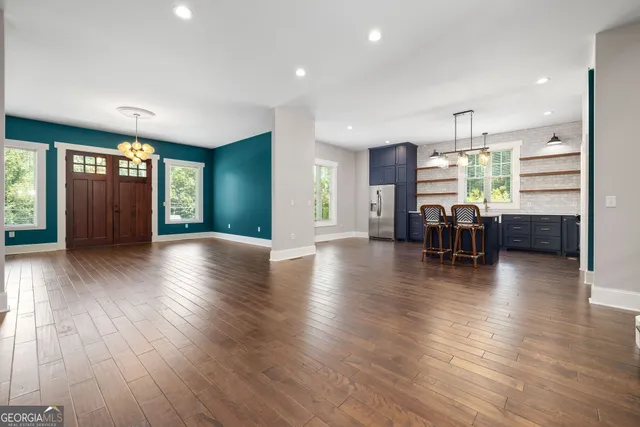 a view of a livingroom with furniture window and wooden floor