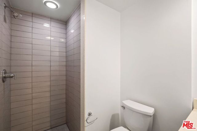 a view of a room with wooden floor and bathroom