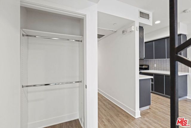 a view of walk in closet with empty racks