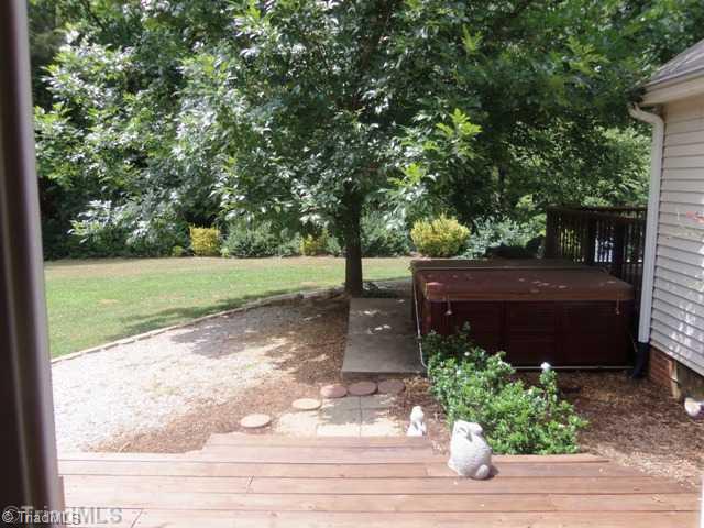 7704 Knollcrest Drive Oak Ridge, NC 27310 - Photo 4 of 16 Exterior Back. Deck off master suite with hot tub
