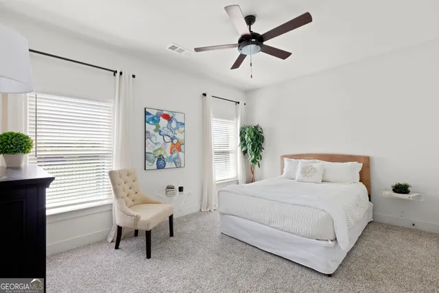 a bedroom with a bed and a painting on the wall