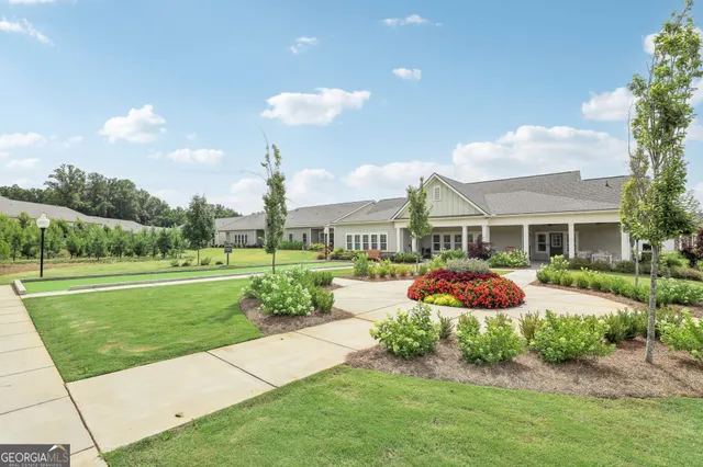 a front view of a house with a yard table and chairs