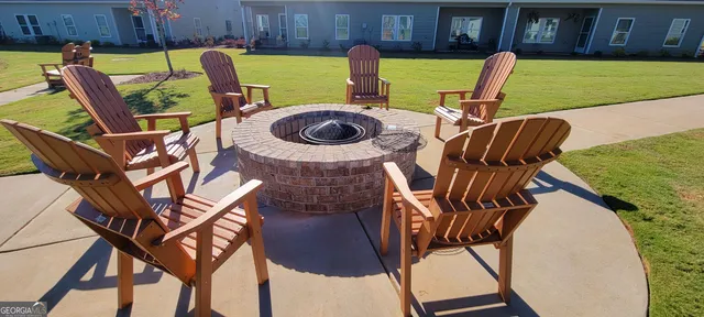 a view of a chairs and table in the backyard