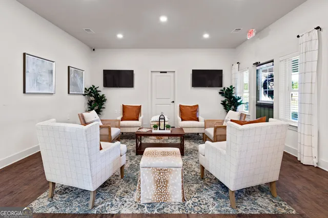 a living room with couches and a flat screen tv