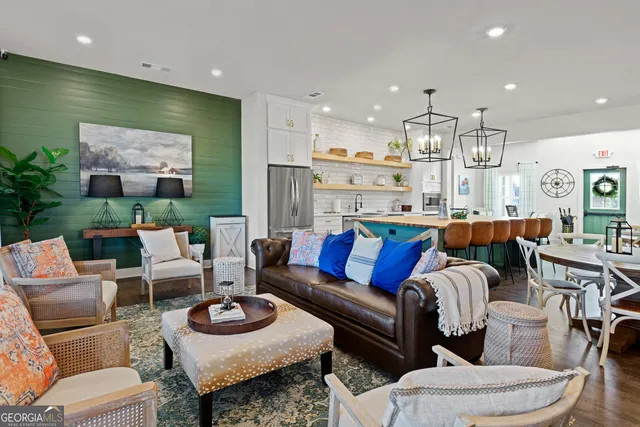 a living room with furniture and a view of kitchen