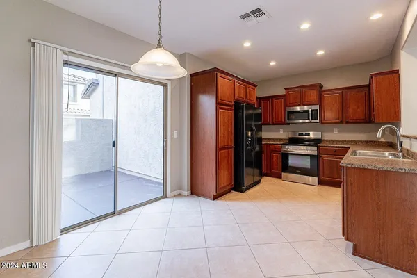 a kitchen with stainless steel appliances granite countertop a refrigerator and a sink