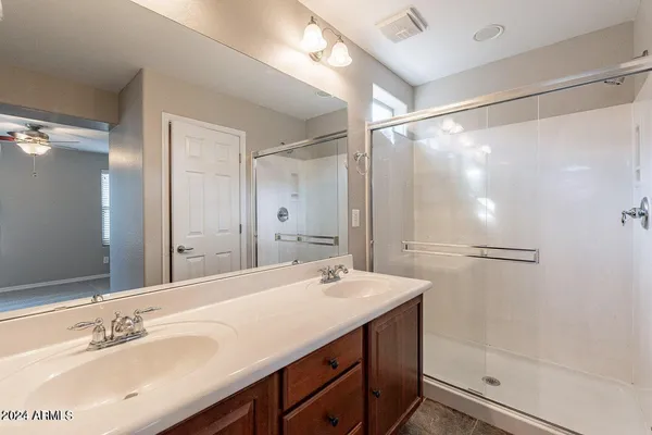 a bathroom with a shower sink and mirror