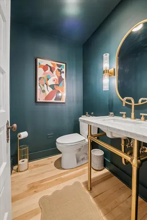 a bathroom with a sink a mirror and a toilet