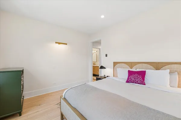 a bedroom with a bed and a night stand