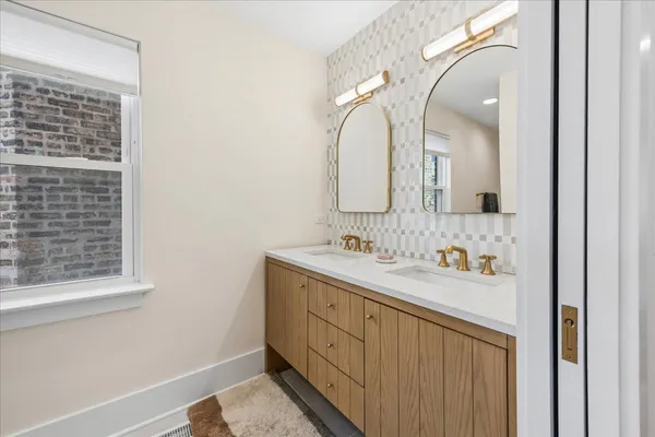 a bathroom with a double vanity sink and mirror