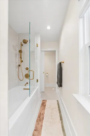a bathroom with a bathtub and a shower