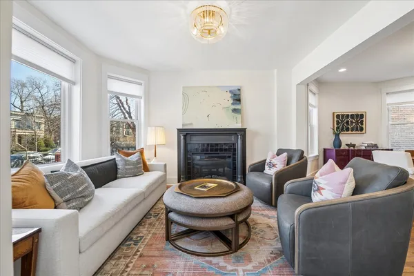 a living room with furniture a window and a fireplace