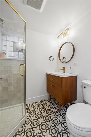 a bathroom with a sink mirror vanity and toilet