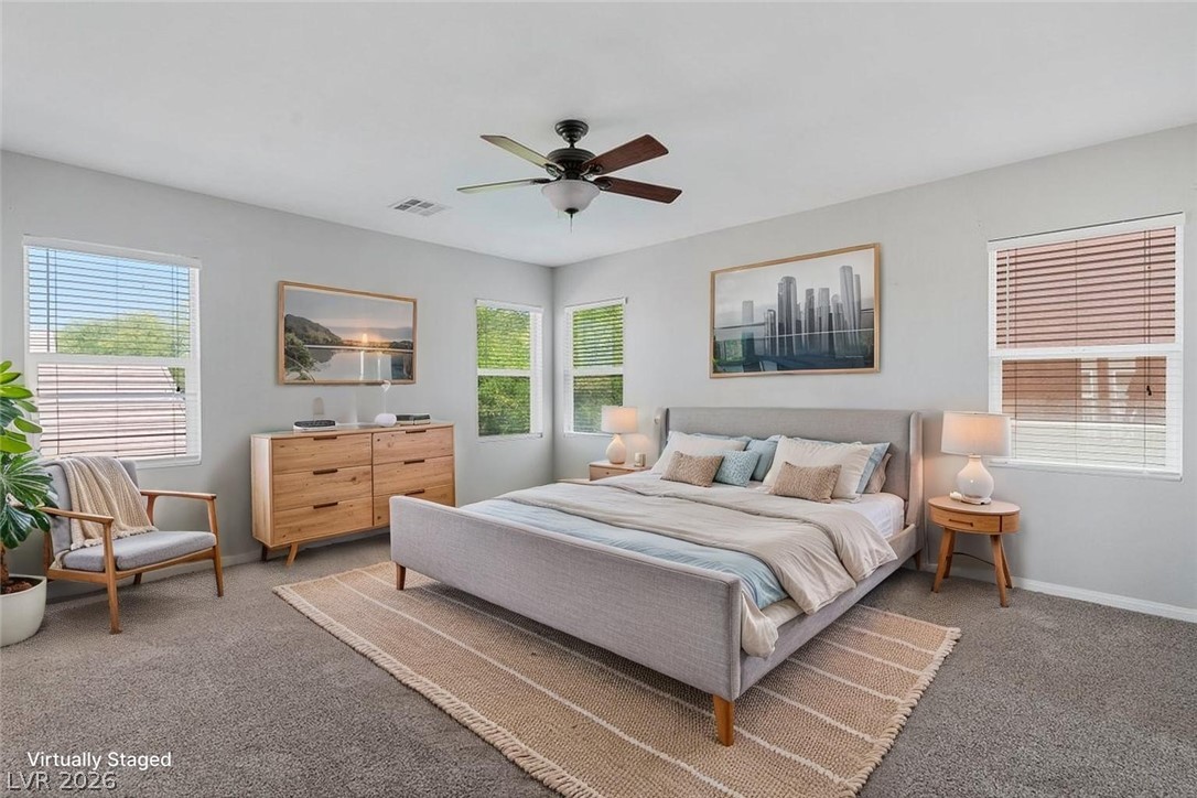 10336 Hawk Ravine Street Las Vegas, NV 89178 - Photo 26 of 59 Virtually Staged! This Spacious Primary Bedroom features ample natural light and plush carpeting for ultimate comfort.