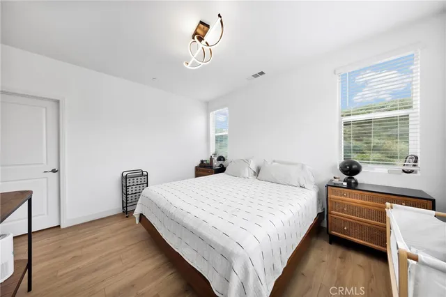 a bedroom with a bed and a chandelier