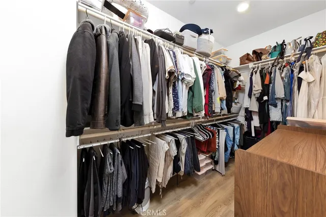 a view of walk in closet with clothes