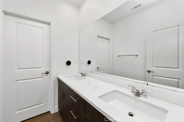 a bathroom with a sink vanity and mirror
