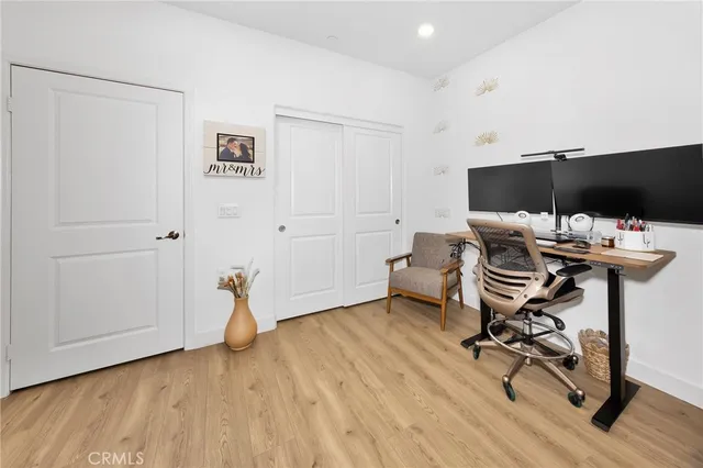 a view of a workspace with furniture and wooden floor