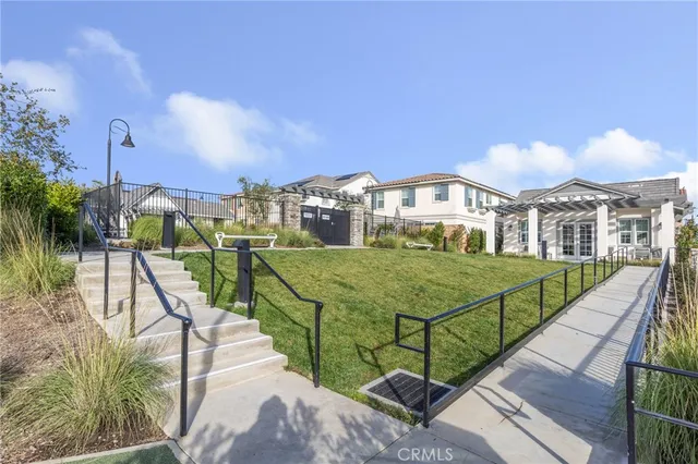 a view of a house with backyard and sitting area
