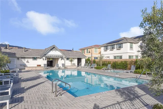 a view of house with yard and sitting area