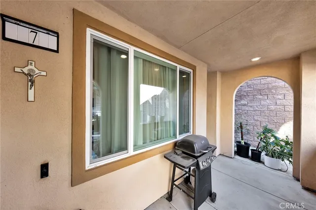 a living room with furniture and a floor to ceiling window