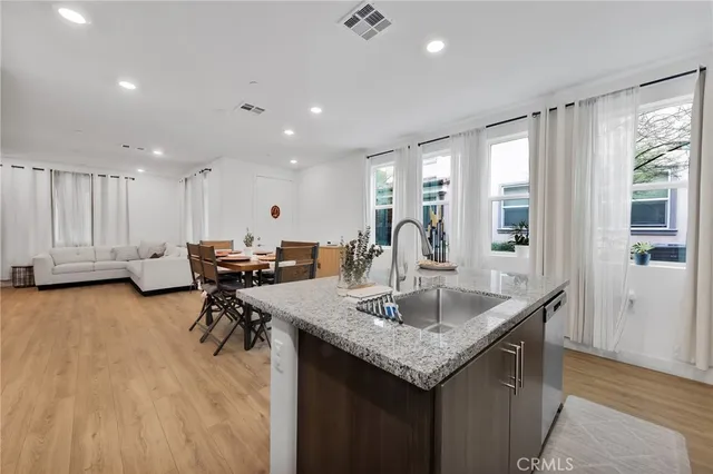 a kitchen with center island table and chairs
