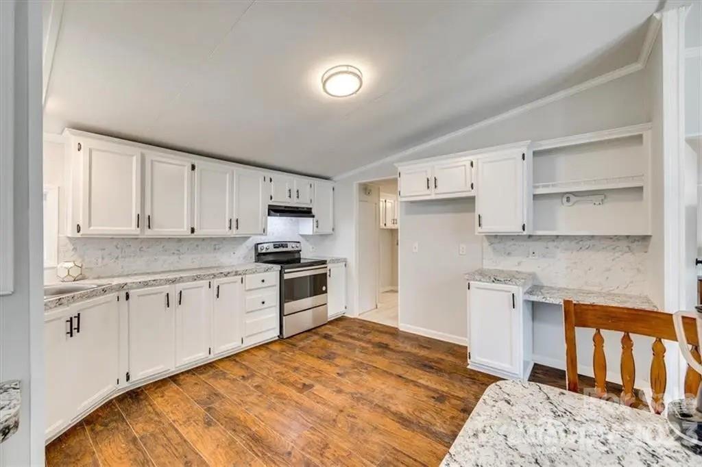 320 North Market Street Lancaster, SC 29720 - Photo 13 of 25 a kitchen with granite countertop a sink stove and refrigerator