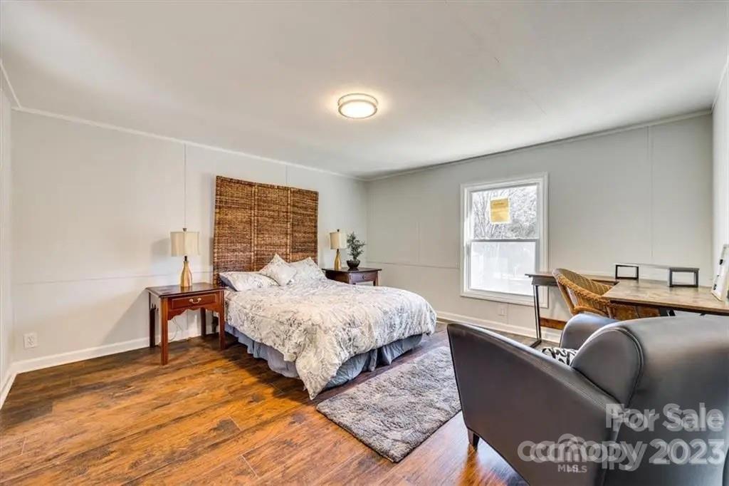 320 North Market Street Lancaster, SC 29720 - Photo 18 of 25 a bed room with a bed and a chair