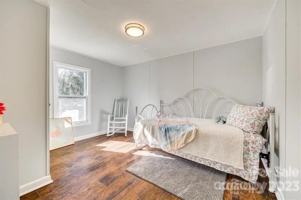 320 North Market Street Lancaster, SC 29720 - Photo 19 of 25 a living room with furniture a window and wooden floor