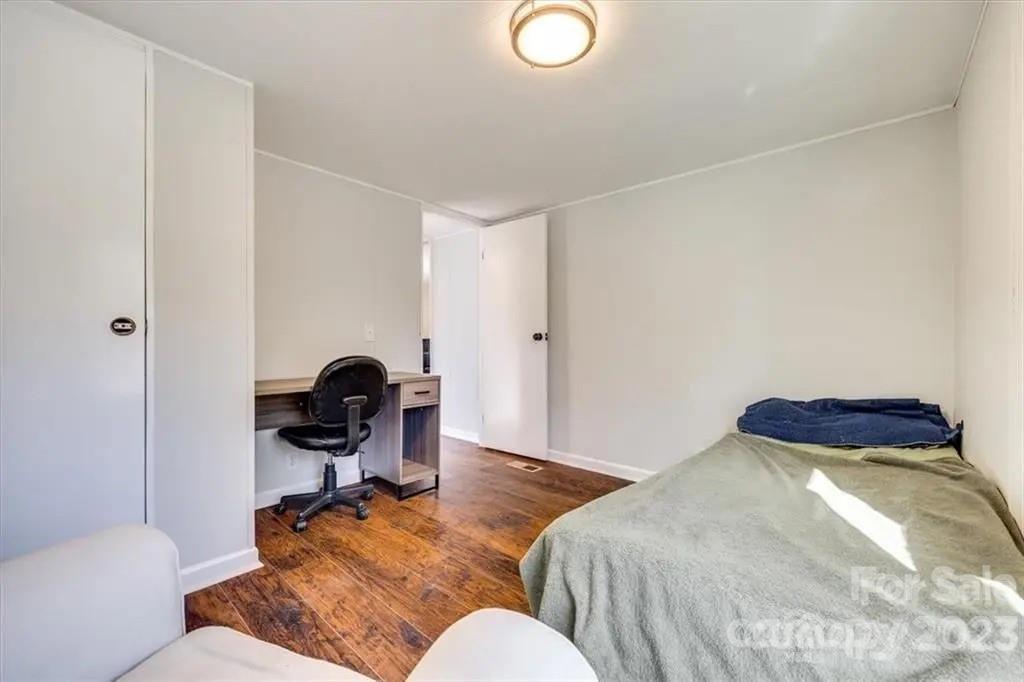 320 North Market Street Lancaster, SC 29720 - Photo 21 of 25 a bedroom with a bed and a workspace