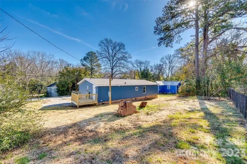 320 North Market Street Lancaster, SC 29720 - Photo 24 of 25 a yellow house with trees in front of it