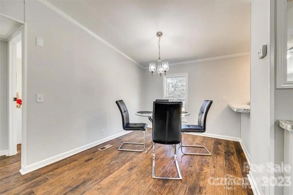 320 North Market Street Lancaster, SC 29720 - Photo 5 of 25 a view of a dining room with furniture a chandelier and wooden floor