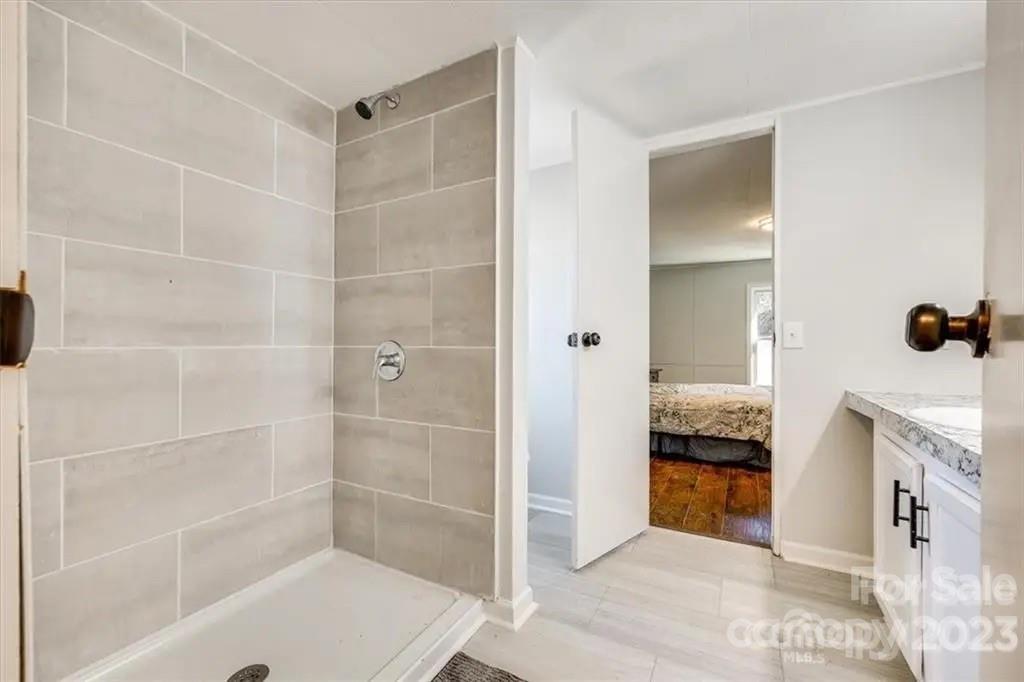 320 North Market Street Lancaster, SC 29720 - Photo 8 of 25 a bathroom with a tub shower and mirror