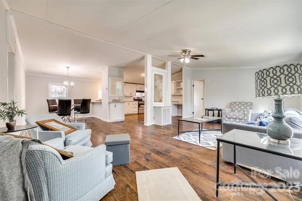 320 North Market Street Lancaster, SC 29720 - Photo 9 of 25 a living room with furniture and a chandelier