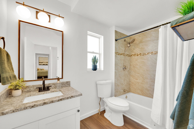 446 South 300 East Provo, UT 84606 - Photo 17 of 32 Bathroom featuring a white vanity with a light-toned countertop, a rectangular undermount sink, and a dark bronze-finish faucet