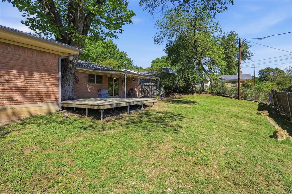 4105 Springbranch Drive Benbrook, TX 76116 - Photo 27 of 30 a view of house with backyard and a garden