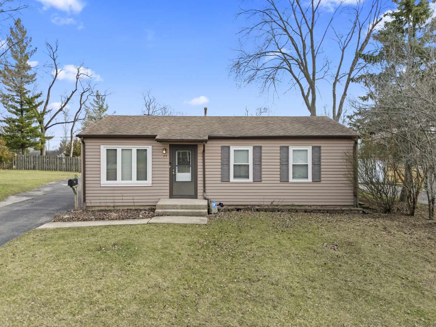 25 McCabe Drive Streamwood, IL 60107 - Photo 1 of 32 a house that has a tree in front of it