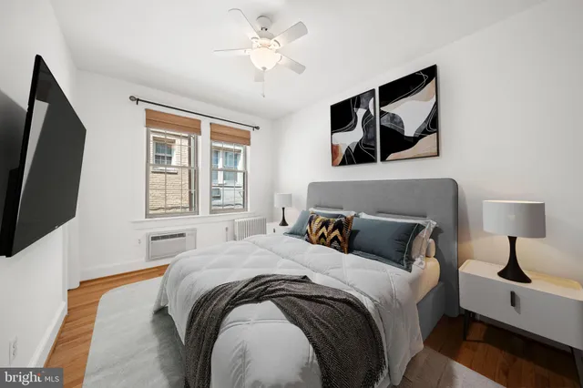a bedroom with a large bed and a flat screen tv