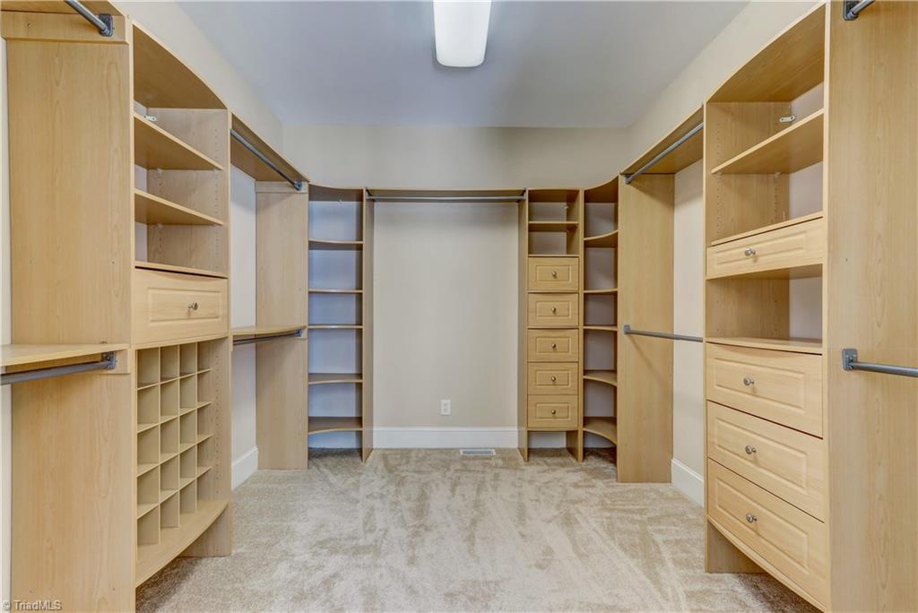 8511 Rosedale Drive Oak Ridge, NC 27310 - Photo 13 of 30 The Master Closet. This space will delight you every day! Wall to wall carpeting, overhead lighting and a place for everything: shoe cubbies, useful corner storage, plenty of hanging, shelving, and drawer storage.