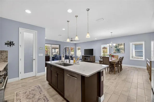a large kitchen with kitchen island a sink counter space and dining table
